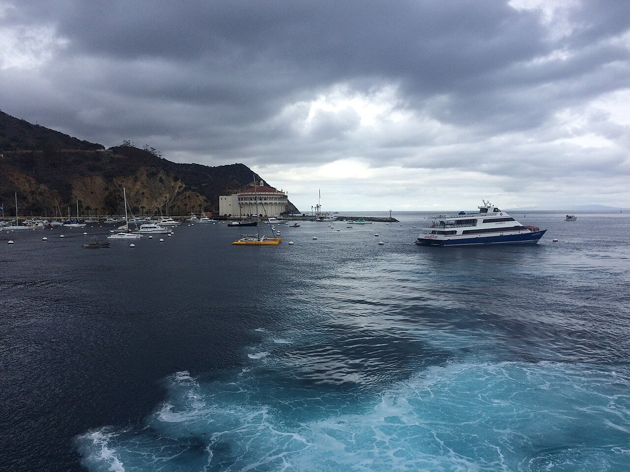 A Catalina Express ferry entering Avalon Harbor under the Casino.