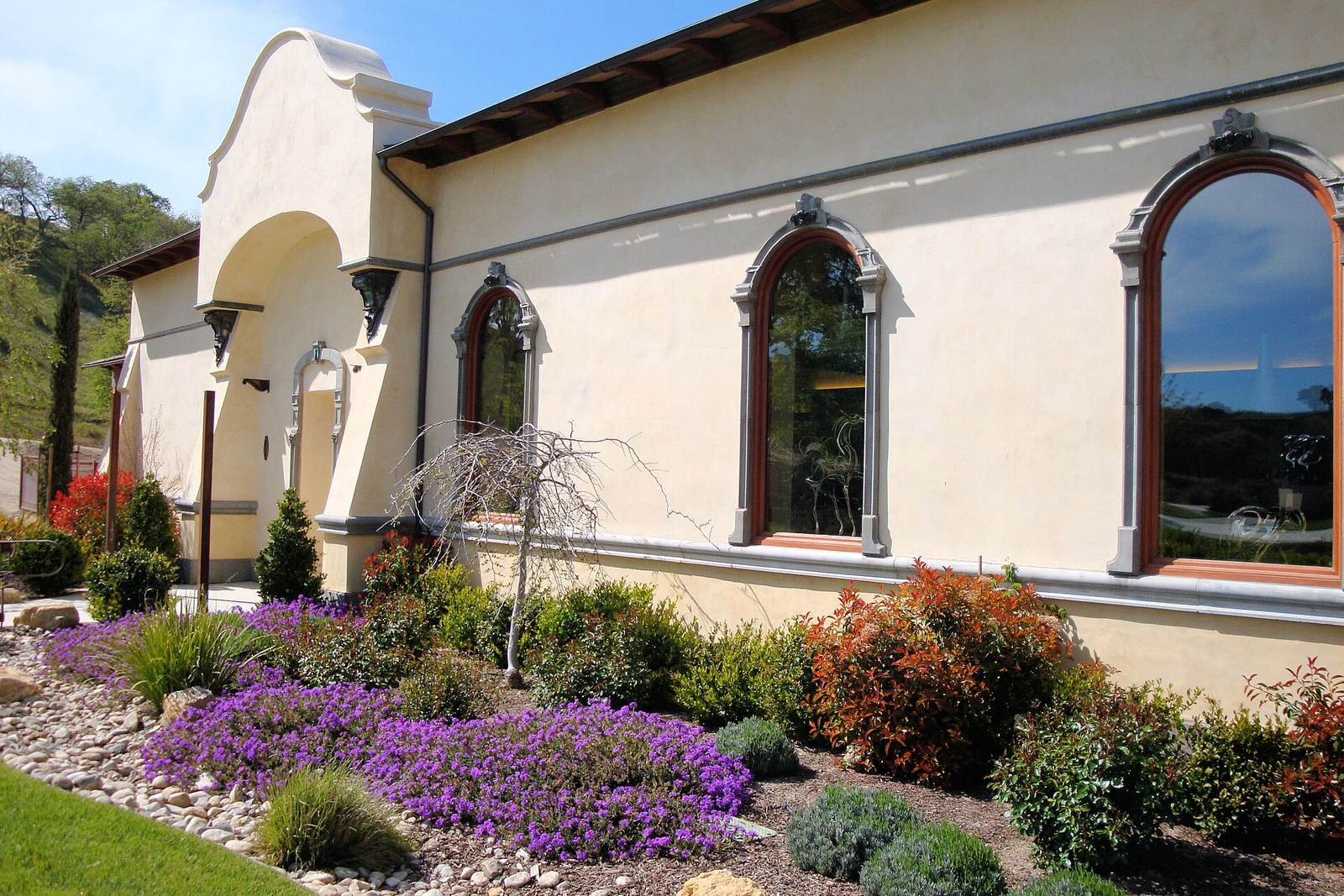 Stucco stay exterior with arched windows, no faces