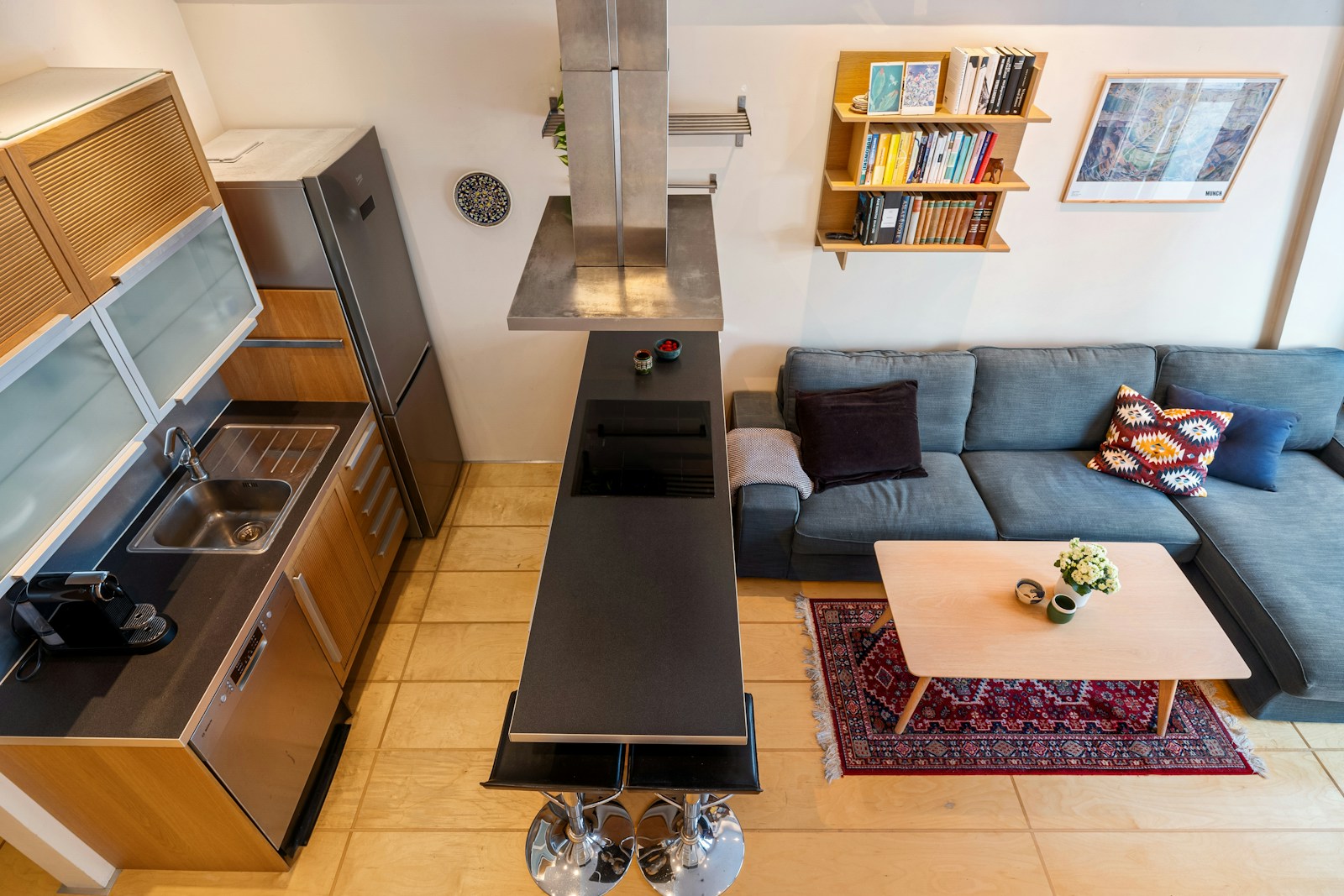 Overhead view of a compact kitchen and sofa, no people