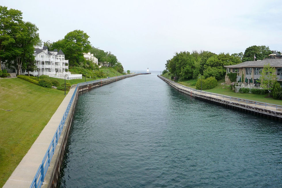 Pine River channel into Lake Michigan and South Pier Light from downtown Charlevoix, Michigan