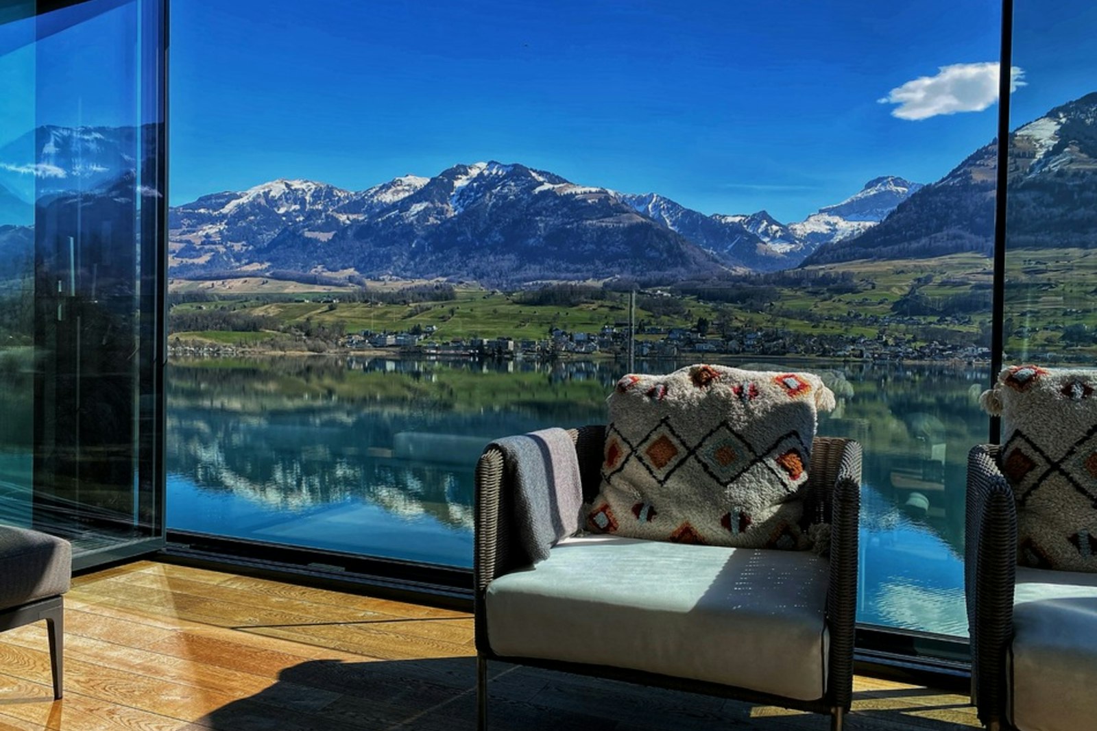 Lake-view rental seating inside a glass wall
