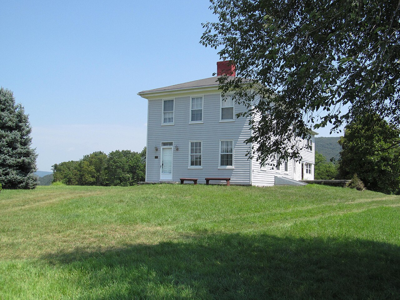 A ridge farmhouse on grass above the Blue Ridge in Jefferson County, West Virginia.