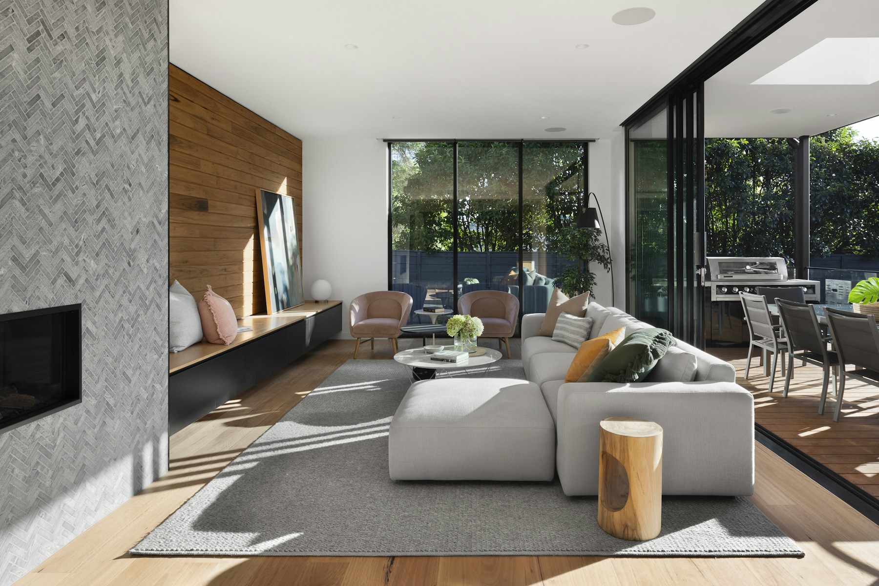 Rental living room with a light sectional opening to a wood deck