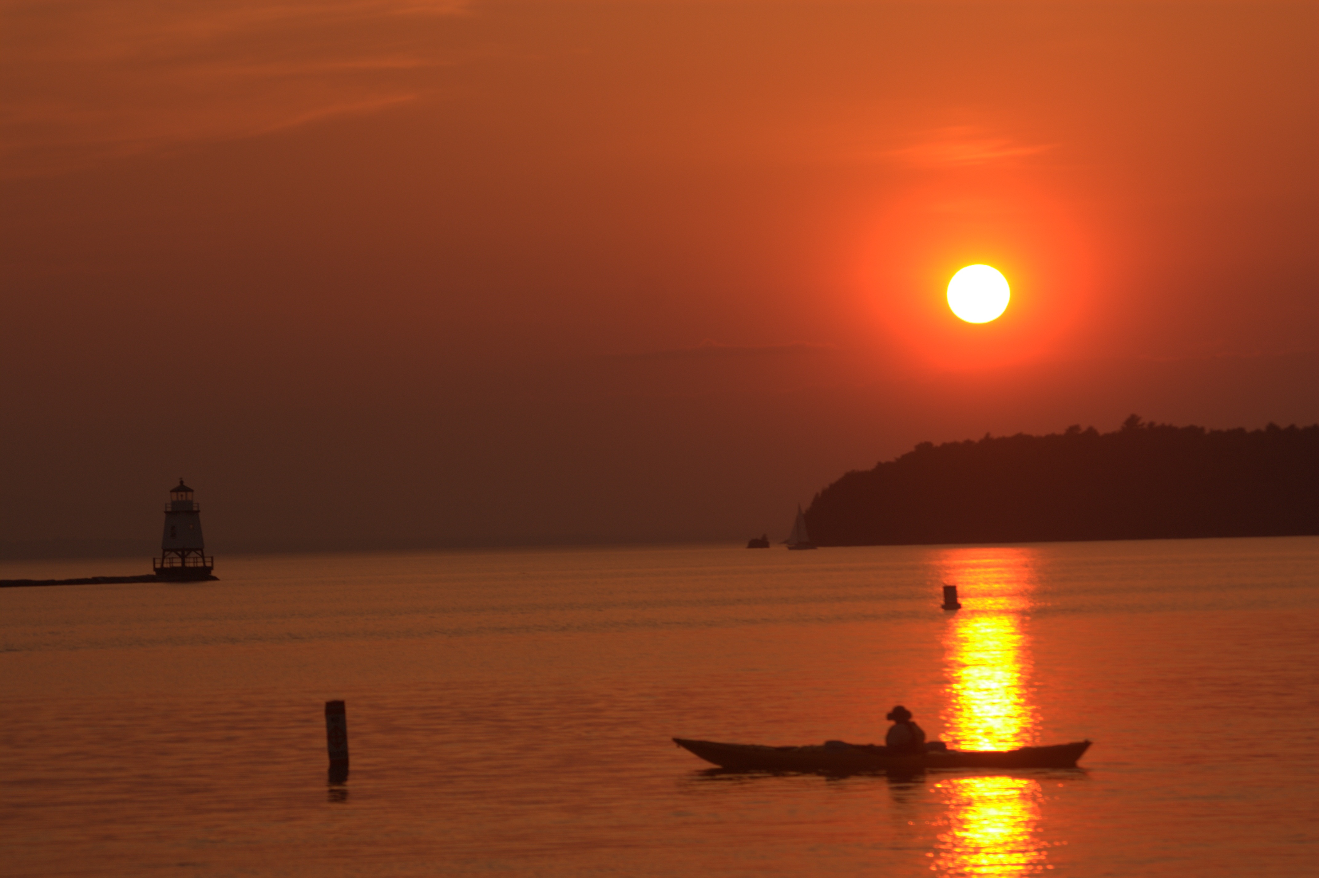 Sunset over Lake Champlain from the Vermont shore. Wikimedia Commons, CC BY-SA 3.0. Caption: Lake Champlain, not a labeled Basin Harbor frame.