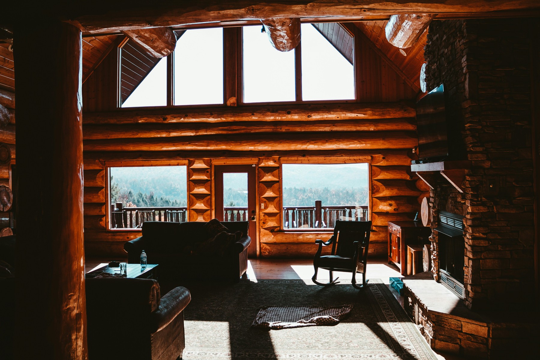 Log-cabin living room and fireplace in a short-term rental