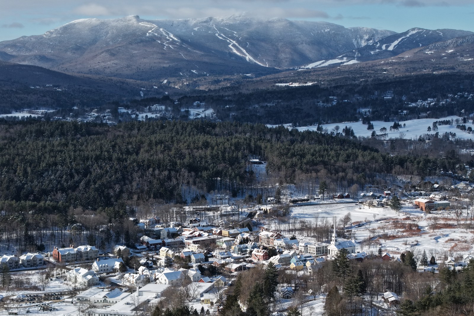 Winter aerial of Stowe village under Mount Mansfield ski trails