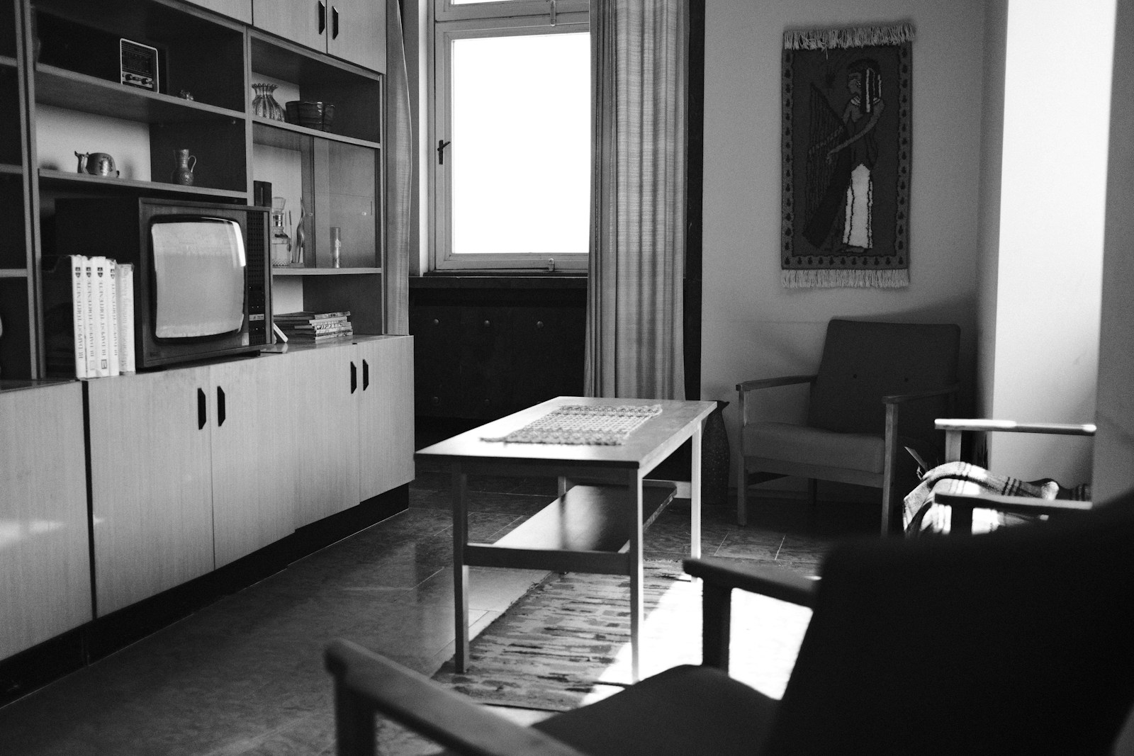 Black-and-white midcentury living room with a cabinet TV, no people