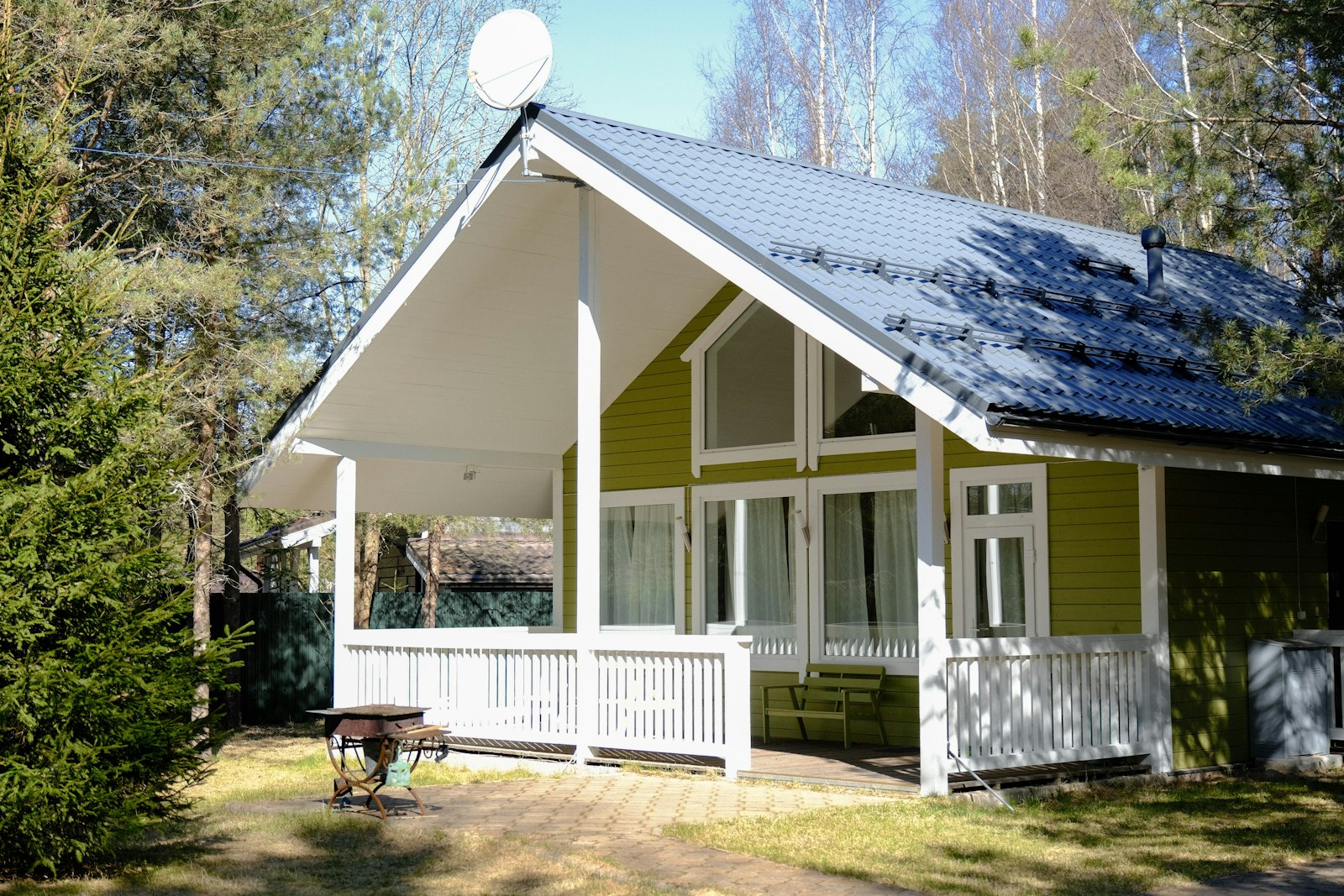 Green cabin with a porch, no faces