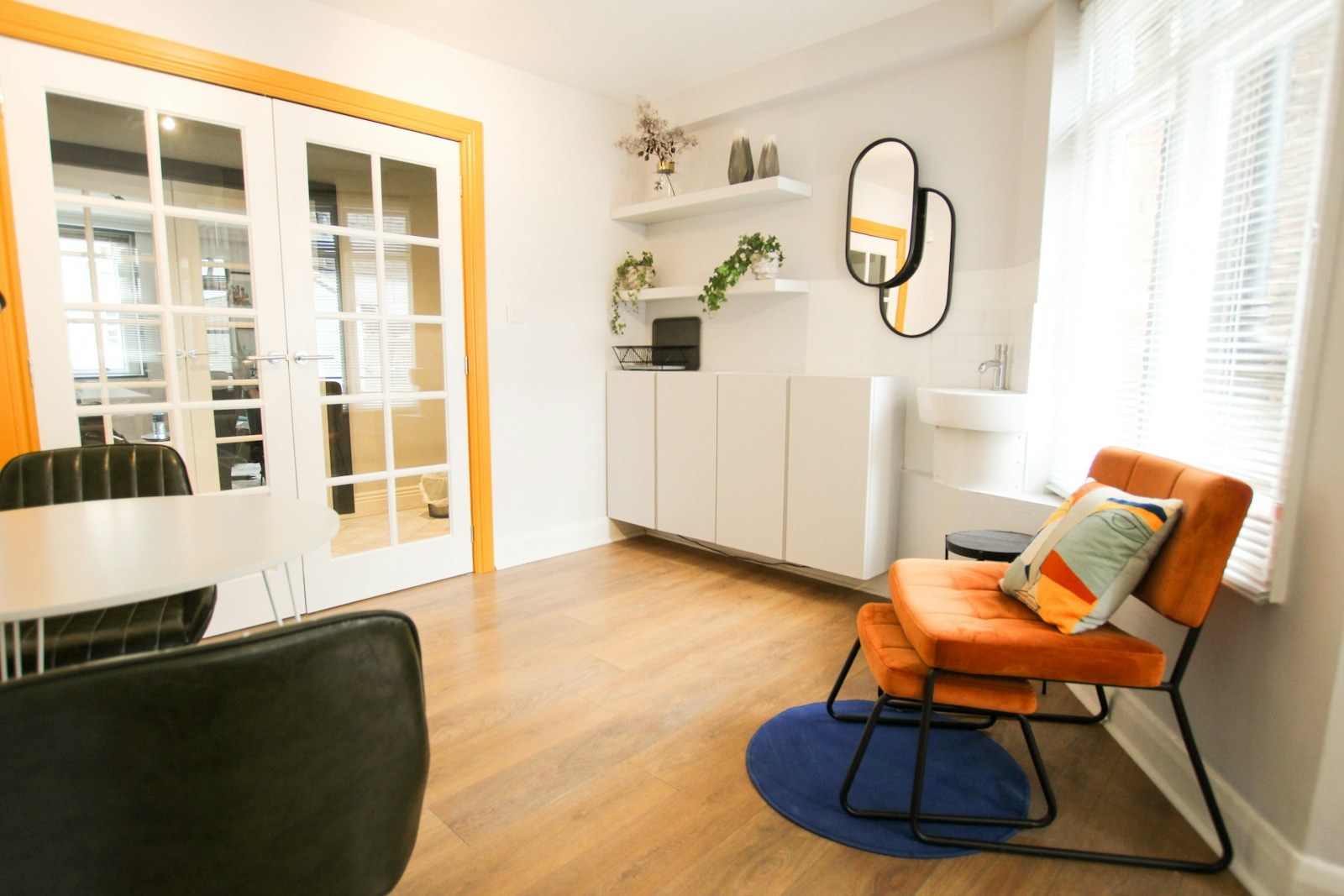 Dining room and orange chair, no faces