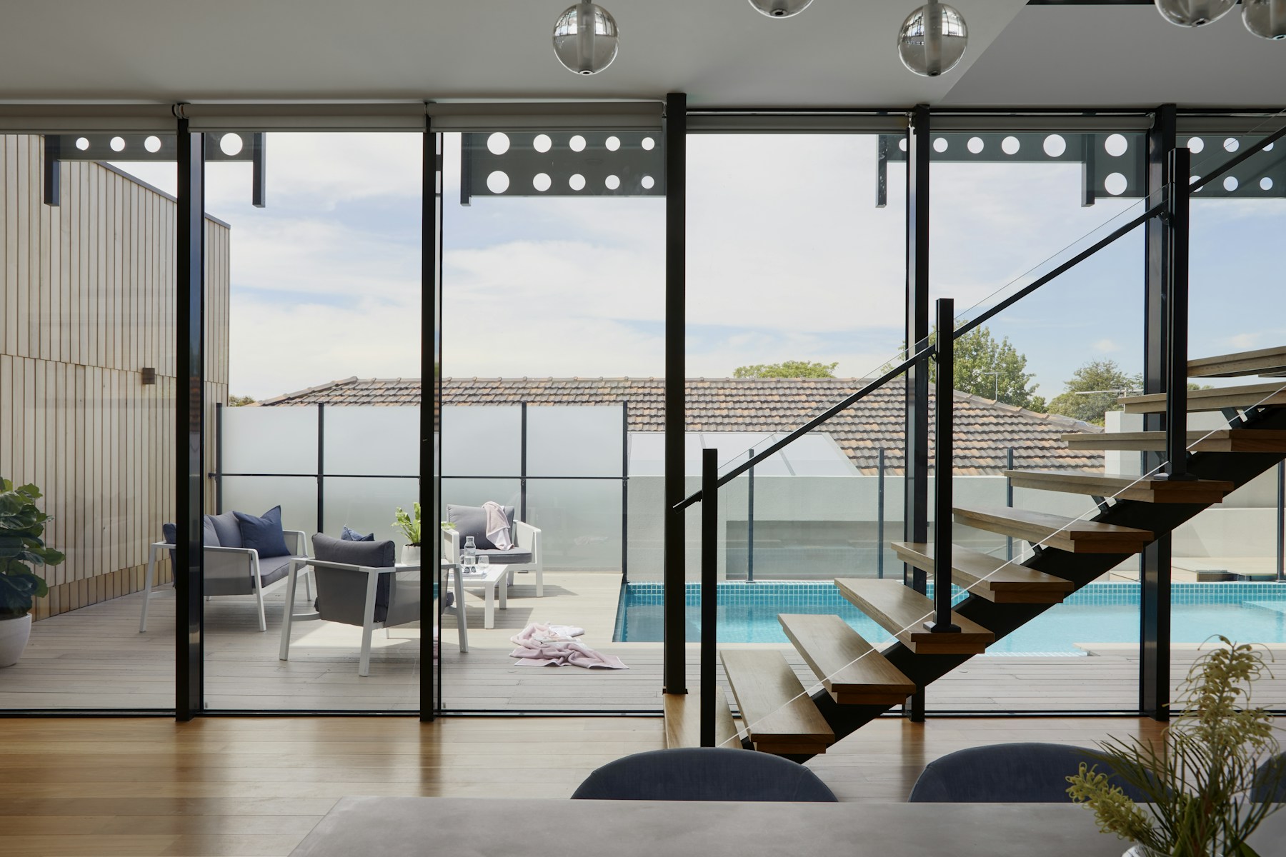 Rental stair and glass wall opening to a small pool deck