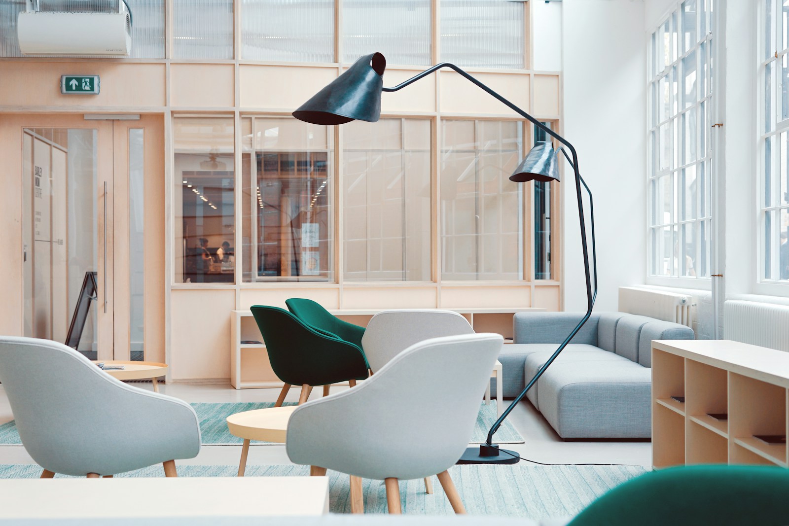 Bright seating area with chairs and floor lamp, no people