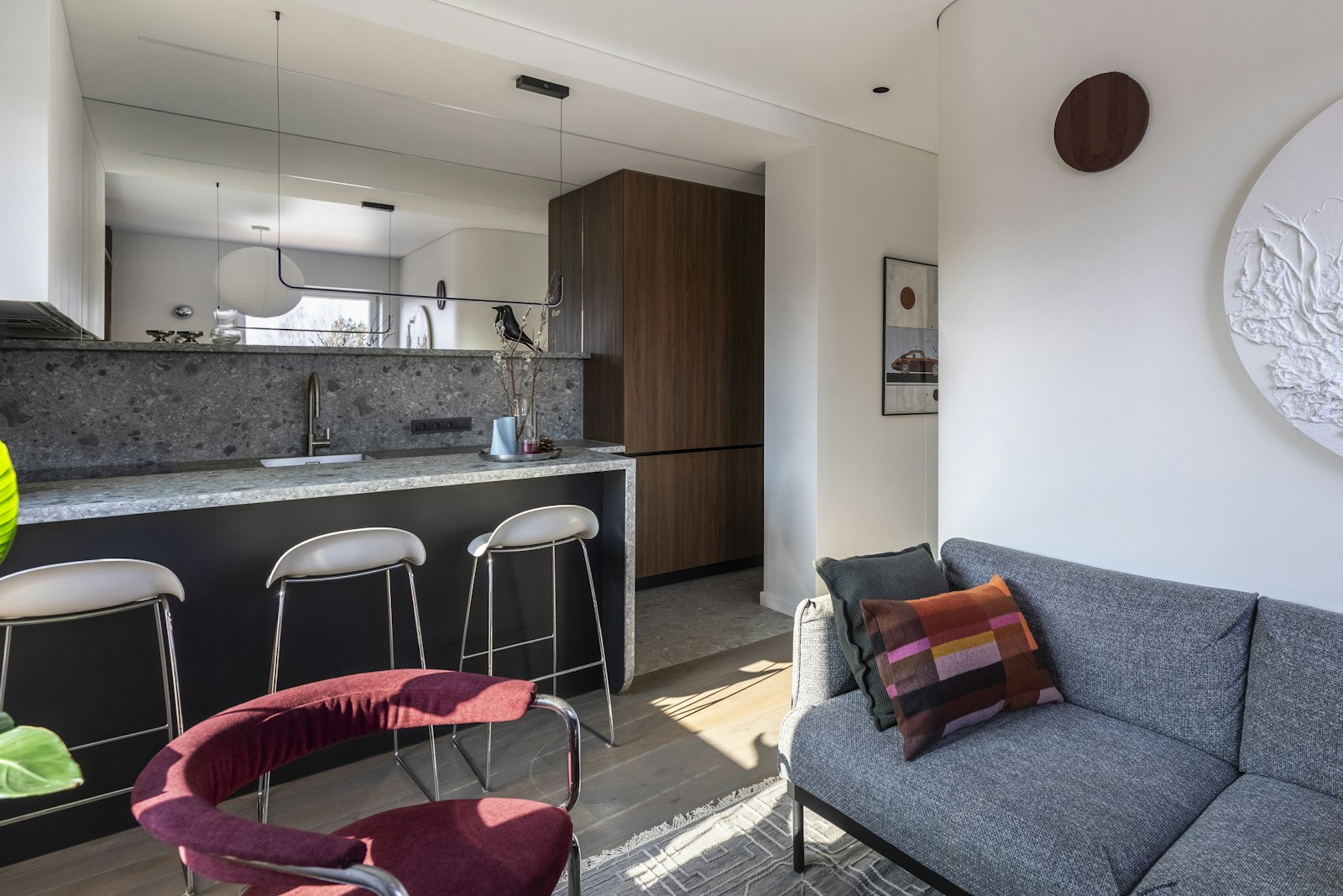 Modern kitchen island and gray sofa, no people
