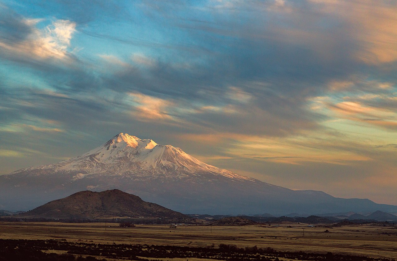 Mount Shasta across the Shasta Valley under evening cloud