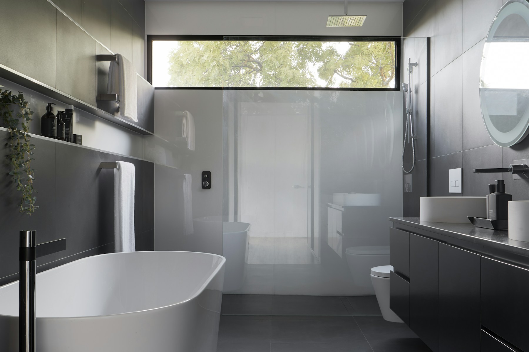 Modern rental bathroom with a freestanding tub and glass shower