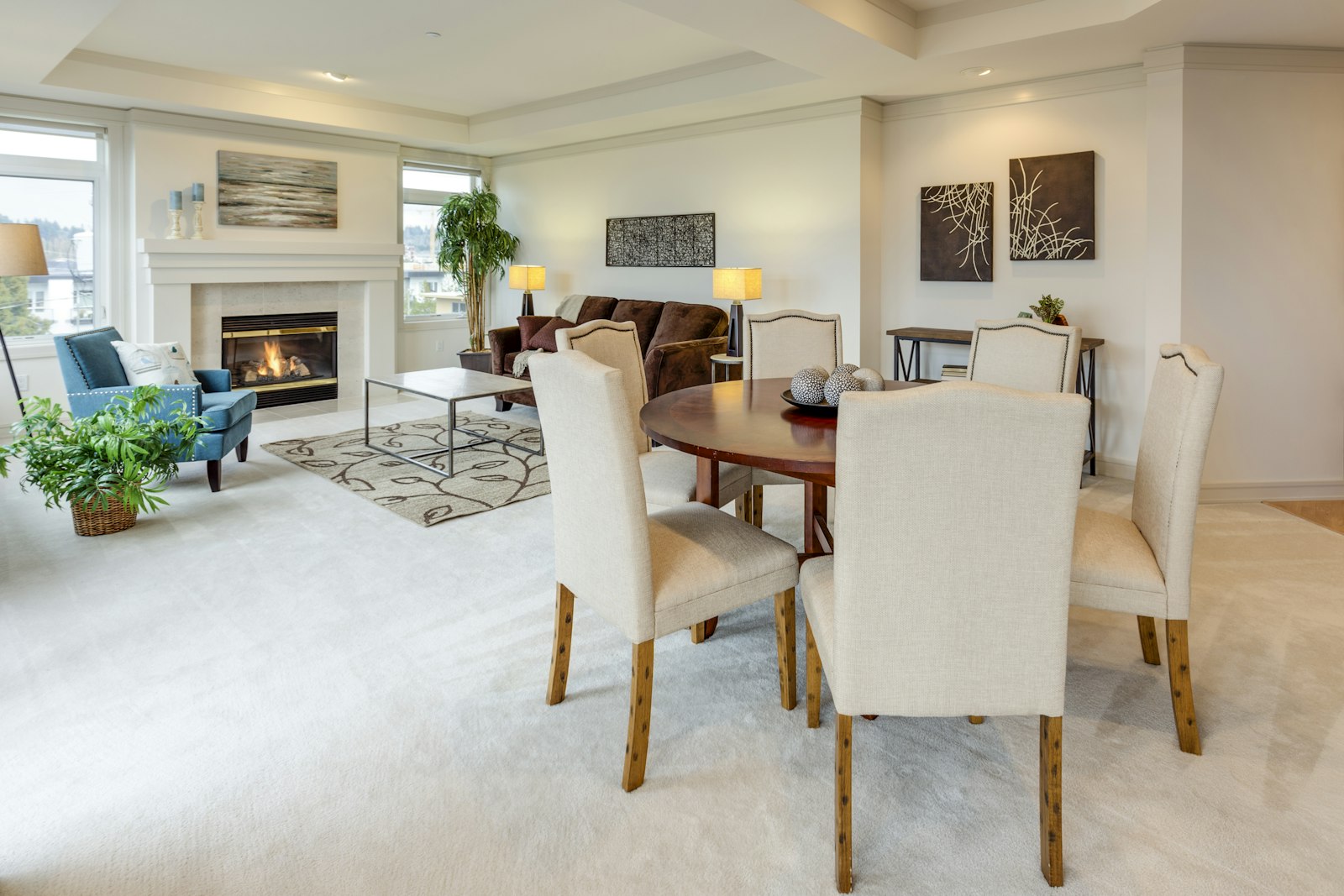 Dining table and living room with a fireplace, no people