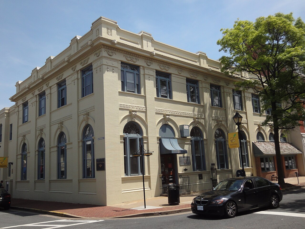 A cream downtown commercial building on a brick sidewalk in Easton.