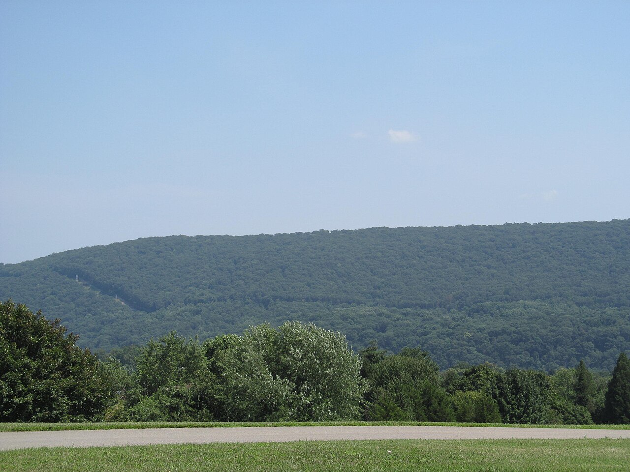 Forested Blue Ridge rising beyond a Jefferson County field in West Virginia.