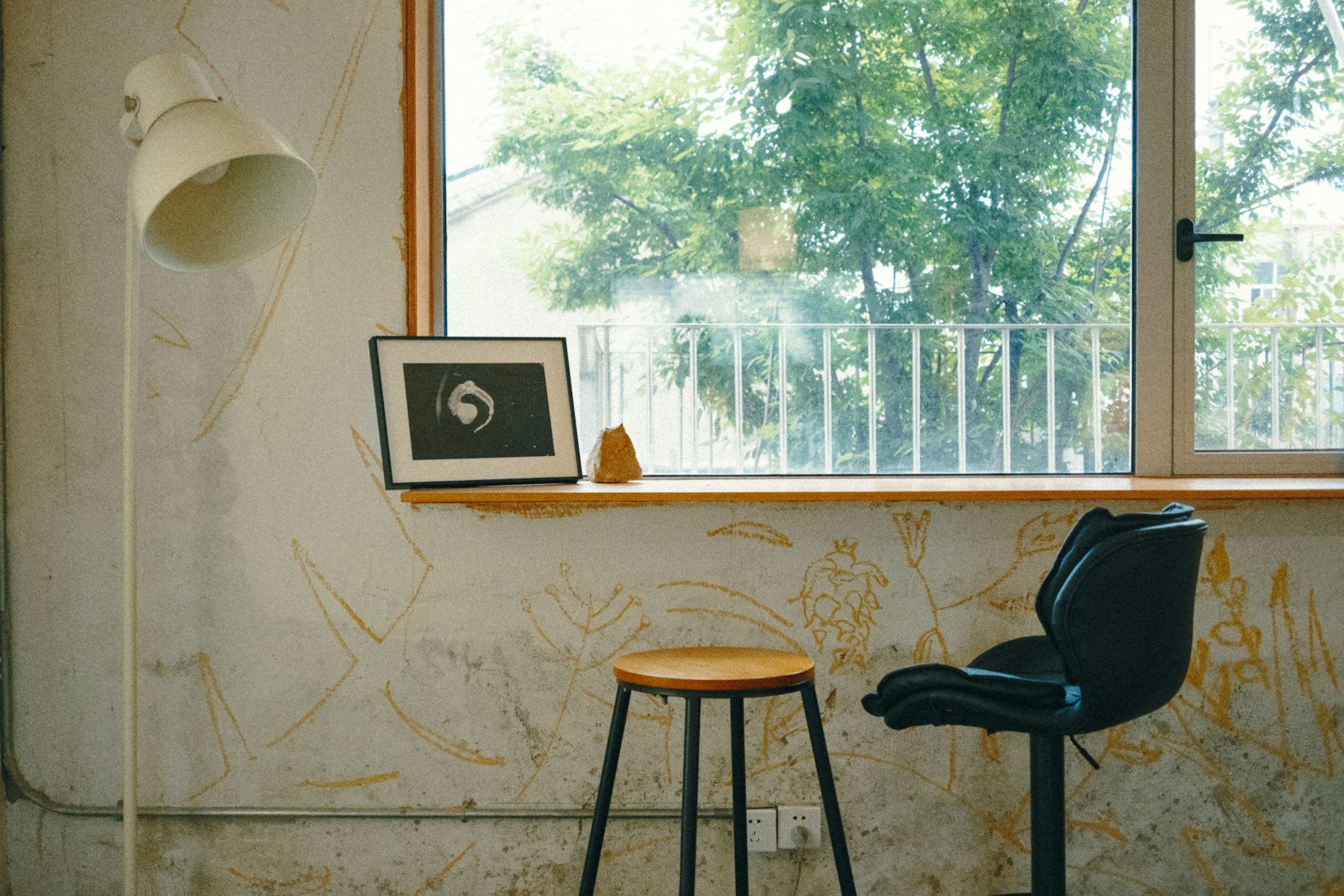 Window seat with a lamp, stool, and chair, no people