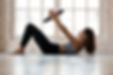 Young sporty attractive woman doing toning pilates exercise for abs with exercise circle,