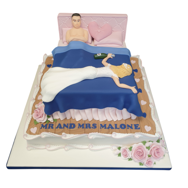 Charming wedding cake decorated with elegant white floral designs on a dark navy blue background, perfect for a night of celebration and romance.