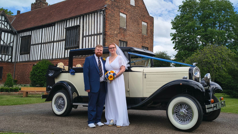 Bridal vintage wedding car outside Gainsborough Old Hall