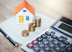 House model and coins. Valuation