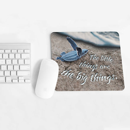 Custom beach-inspired mouse pad featuring a baby turtle and the phrase "the little things are the big things." Intricate texturing, soft natural palette.