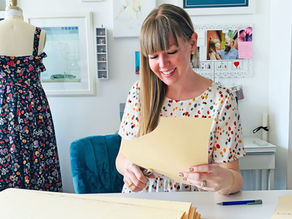 A woman drafting a sewing pattern