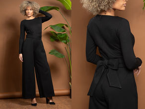 A black jumpsuit with a bow at the back waist
