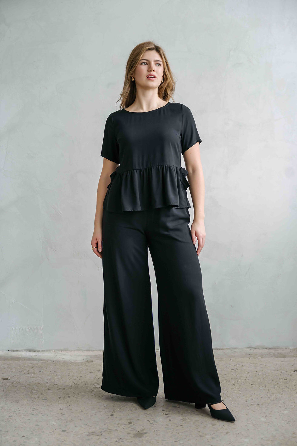 Thumbnail: black peplum top with bows