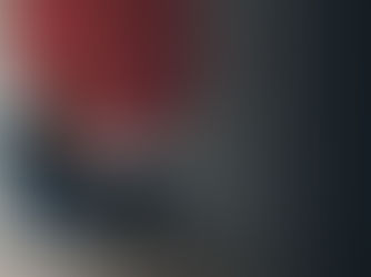 A woman sitting in an office working on a laptop that has marketing metrics