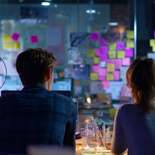 Marketing team planning a content strategy with sticky notes on a collaborative whiteboard.