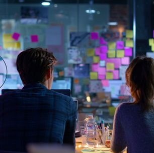 Marketing team planning a content strategy with sticky notes on a collaborative whiteboard.