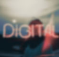 A woman walking on the beach with the word digital lit up like a neon sign