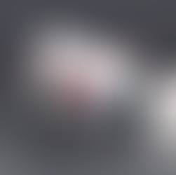 A laptop sitting on  a slanted table with the Reason Why Website and a mobile phone with a screen shot of the Reason Why Website