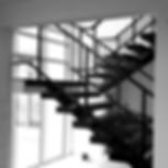Staircase with large window spanning over two floors