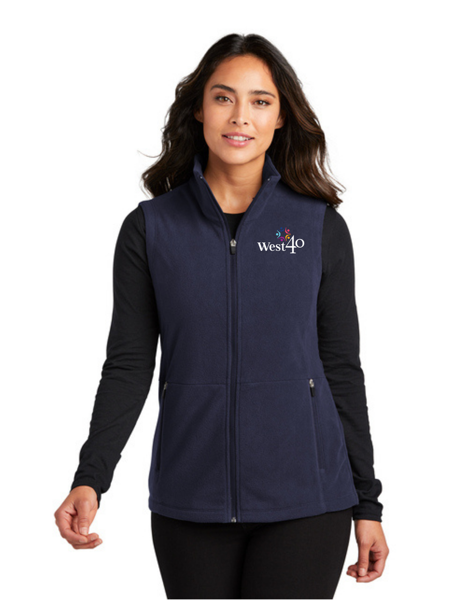 Woman wearing navy vest with Walmart logo, Port Authority® Silk Touch™ Performance 1/4-Zip (K584).