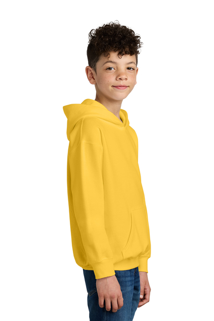 Young boy wearing a yellow hoodie, smiling, with a white background.