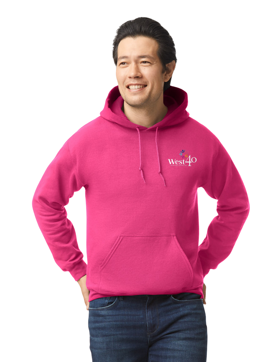 Smiling man in a pink hoodie with West40 logo, looking away.