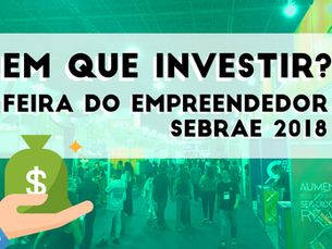 Imagem mostra uma sala com pessoas, um banco de dinheiro e um texto que diz "Quem está investindo? Empreendedor". Há também um logotipo da feira "Sebrão 2018" e o preço do ingresso. A imagem parece estar relacionada a uma feira de negócios ou evento empresarial.