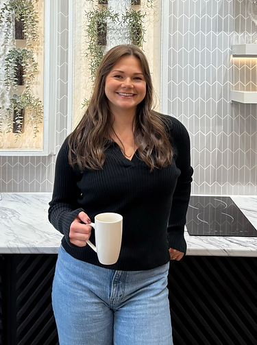 woman in a kitchen holding a coffee