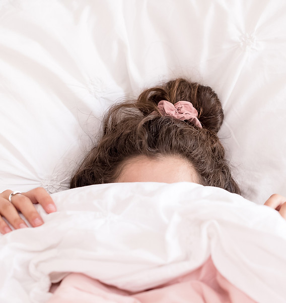 woman in bed under the covers