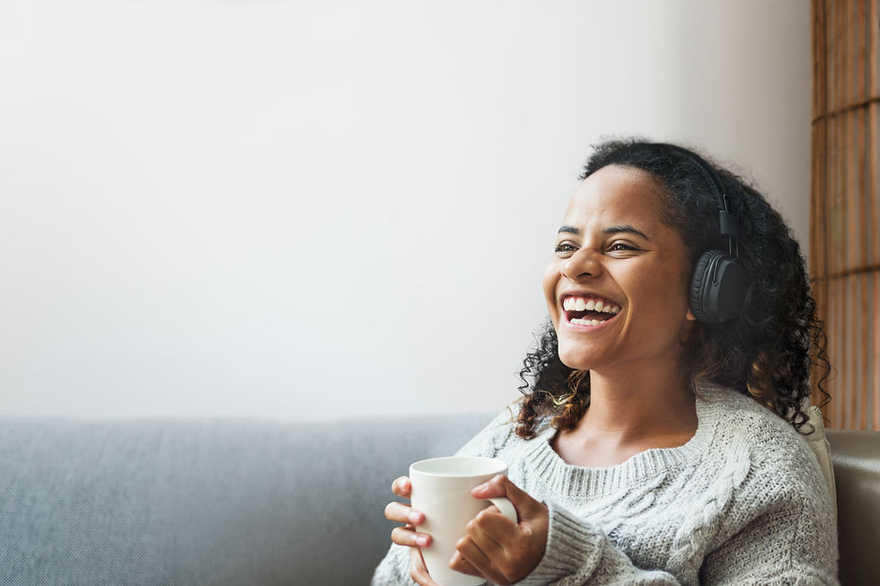 woman with headphones on and a coffee mug