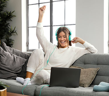 adult woman wearing headset with laptop engaged in global village with other parents and caregivers