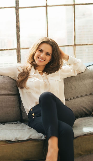 femme assise sur un canapé souriant