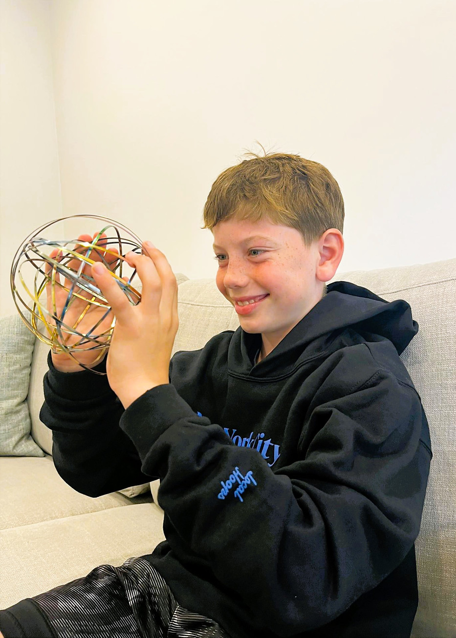 young boy with wire ball