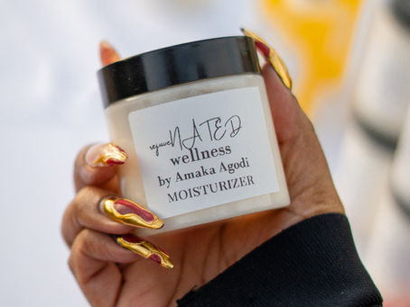 Business owner holding Maison Agodi moisturizer