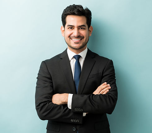 smiling-young-male-professional-standing-with-arms-crossed-while-making-eye-contact-agains