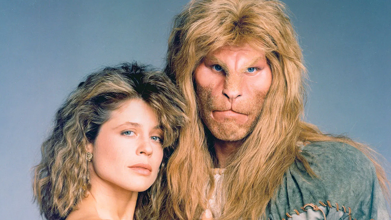 Image of a blonde-haired woman embraced by a lion-looking man for the TV show Beauty and the Beast