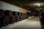 wine wooden barrels inside the undeground tunnels of a winery.jpg